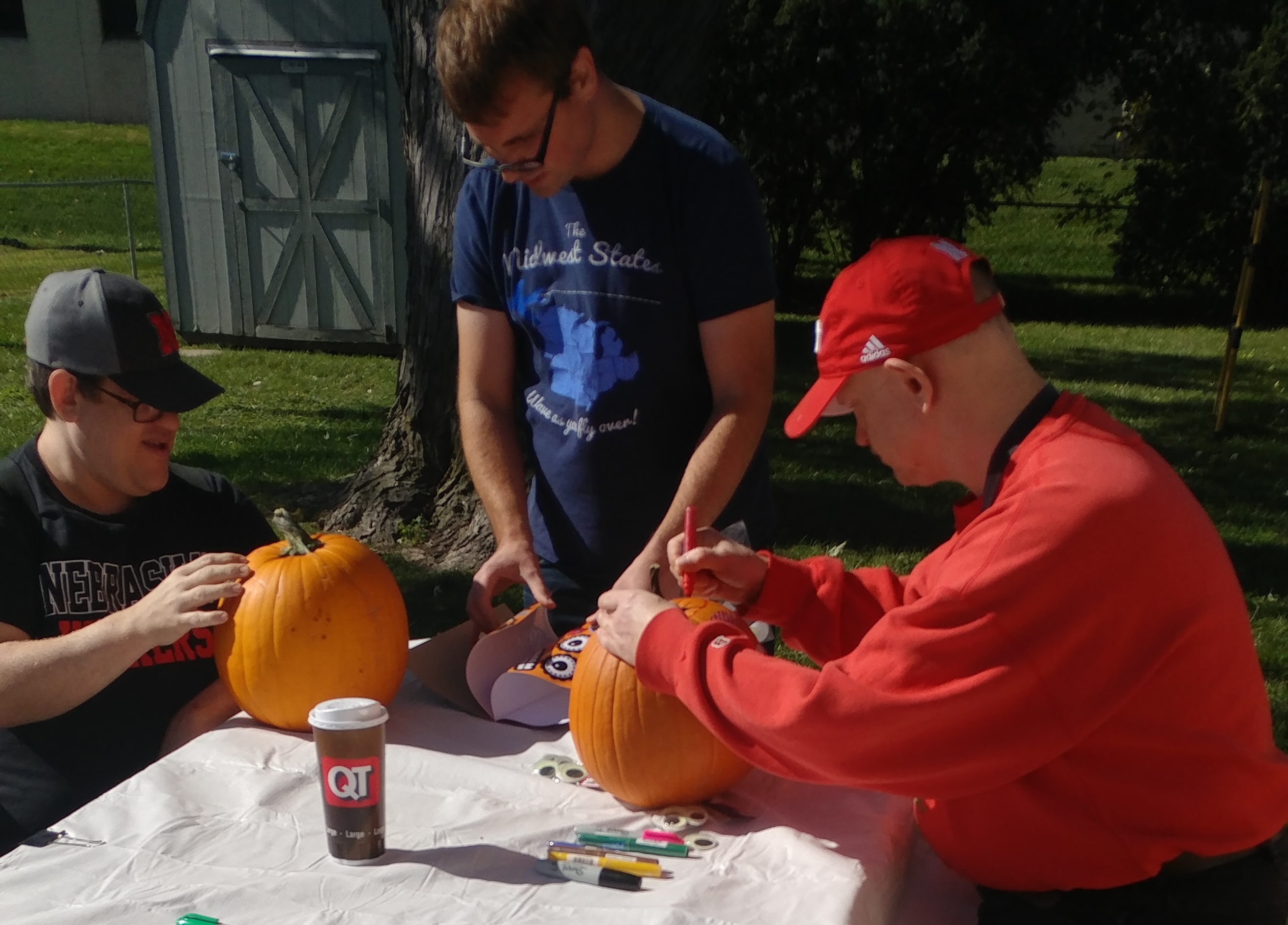 Chris Scott and Matt decorating pumpkins